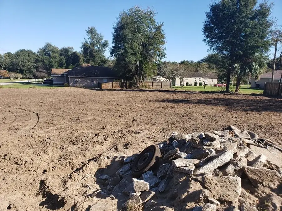 Pile of broken concrete slab and demolition debris stacked for removal on a cleared Ocala lot